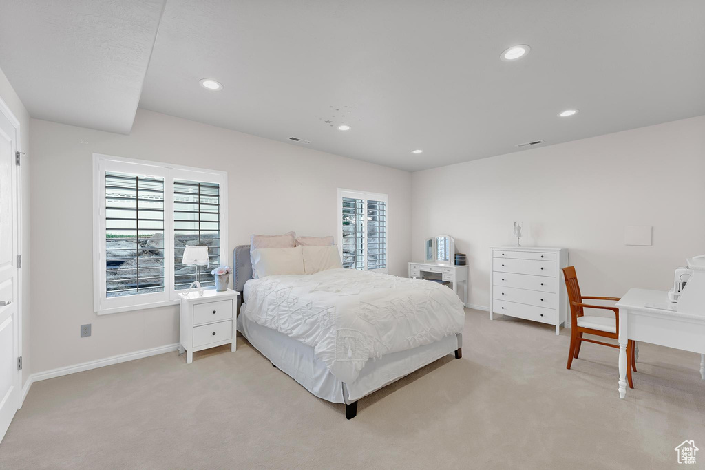 Bedroom featuring light colored carpet, baseboards, and recessed lighting