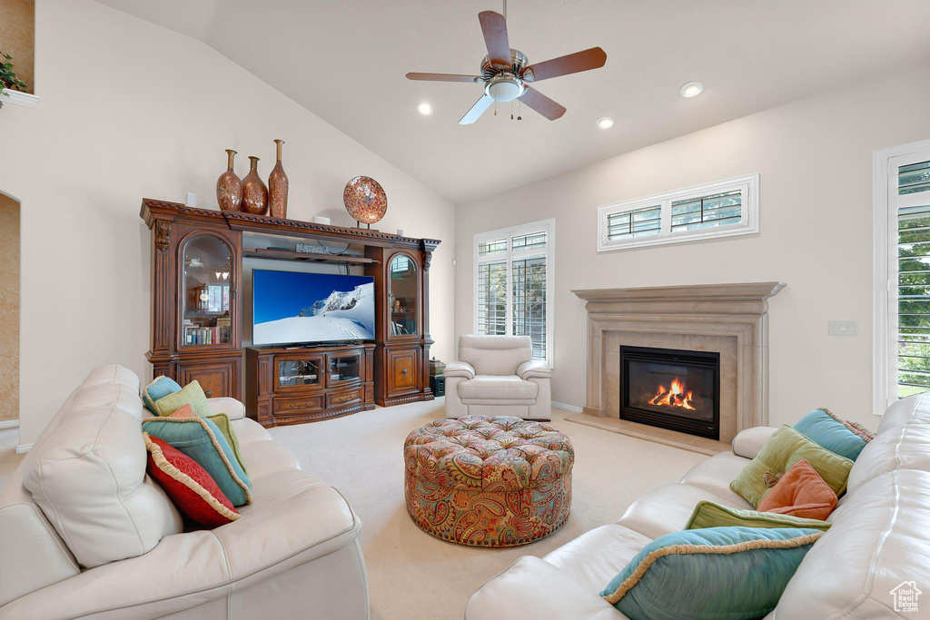 Carpeted living area featuring vaulted ceiling, a ceiling fan, a premium fireplace, and recessed lighting