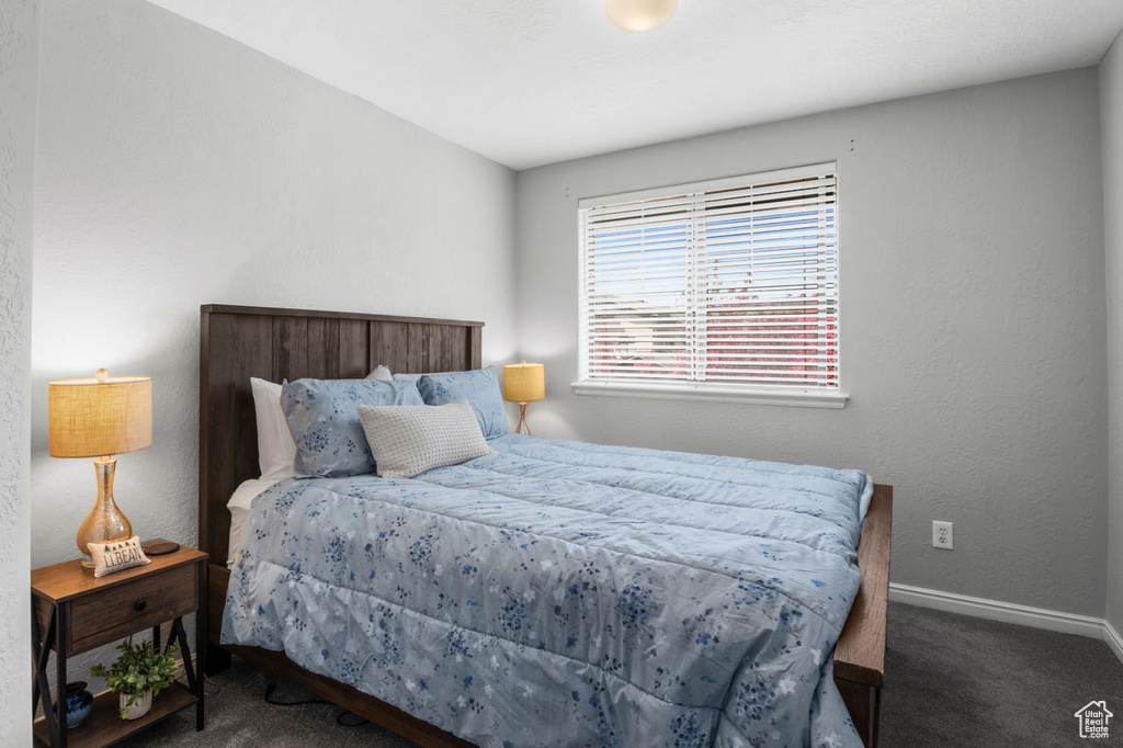 Carpeted bedroom with baseboards