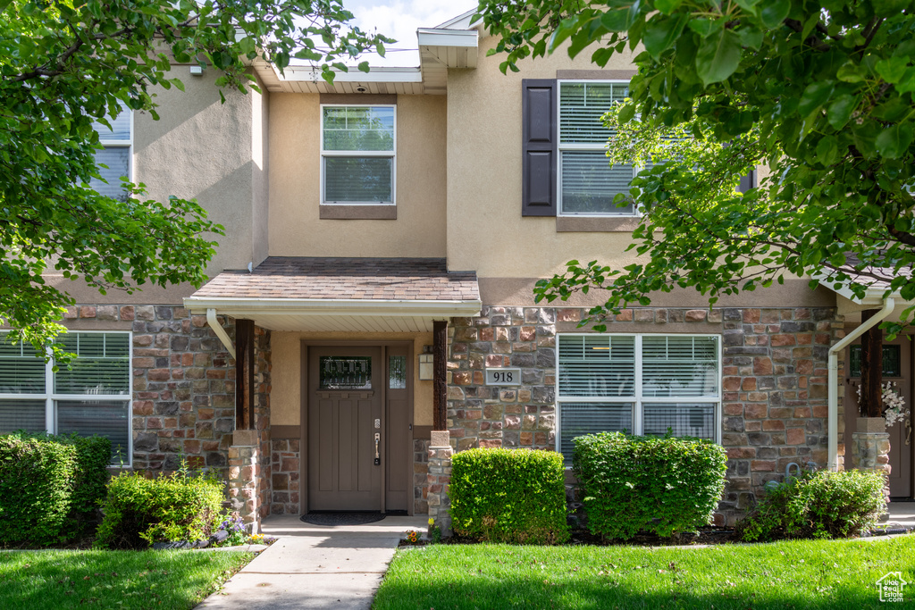 Property entrance with stucco siding and stone siding
