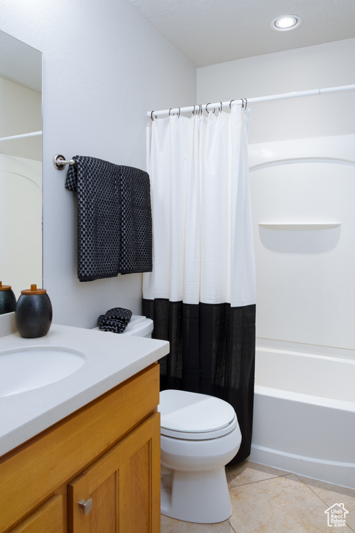 Bathroom with tile patterned floors, toilet, vanity, shower / bath combination with curtain, and recessed lighting