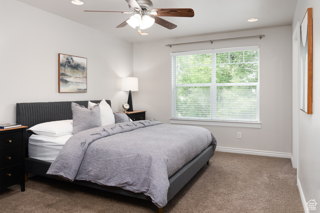Carpeted bedroom with baseboards, recessed lighting, and a ceiling fan