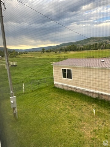 Yard at dusk featuring a rural view