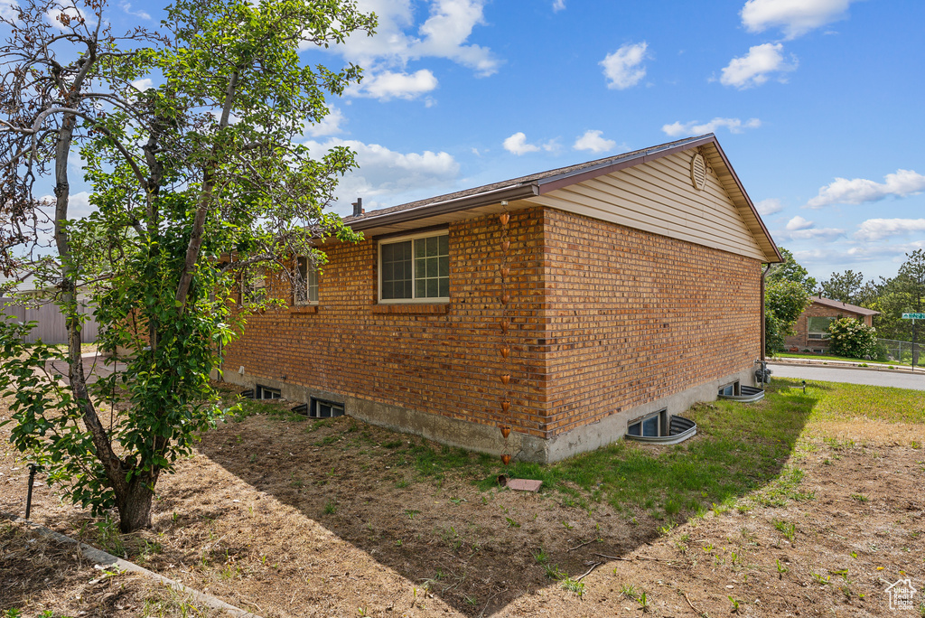 View of side of home featuring brick siding