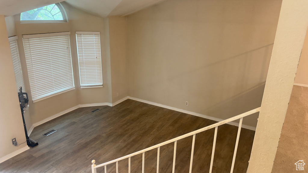 Bonus room featuring wood finished floors, lofted ceiling, and baseboards