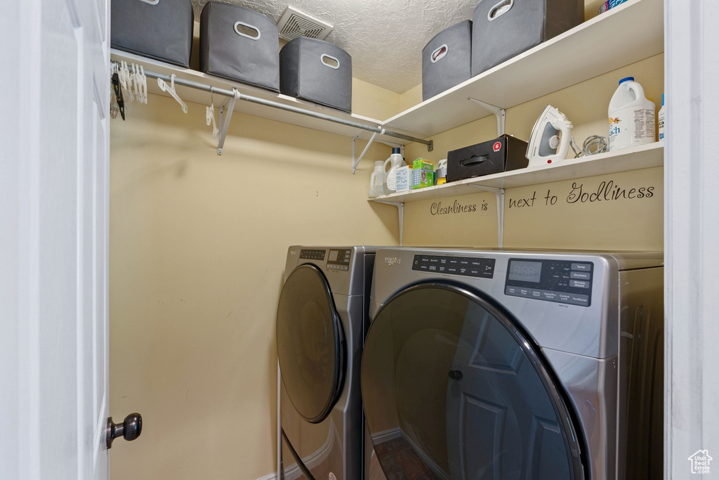 Laundry area with washer and clothes dryer