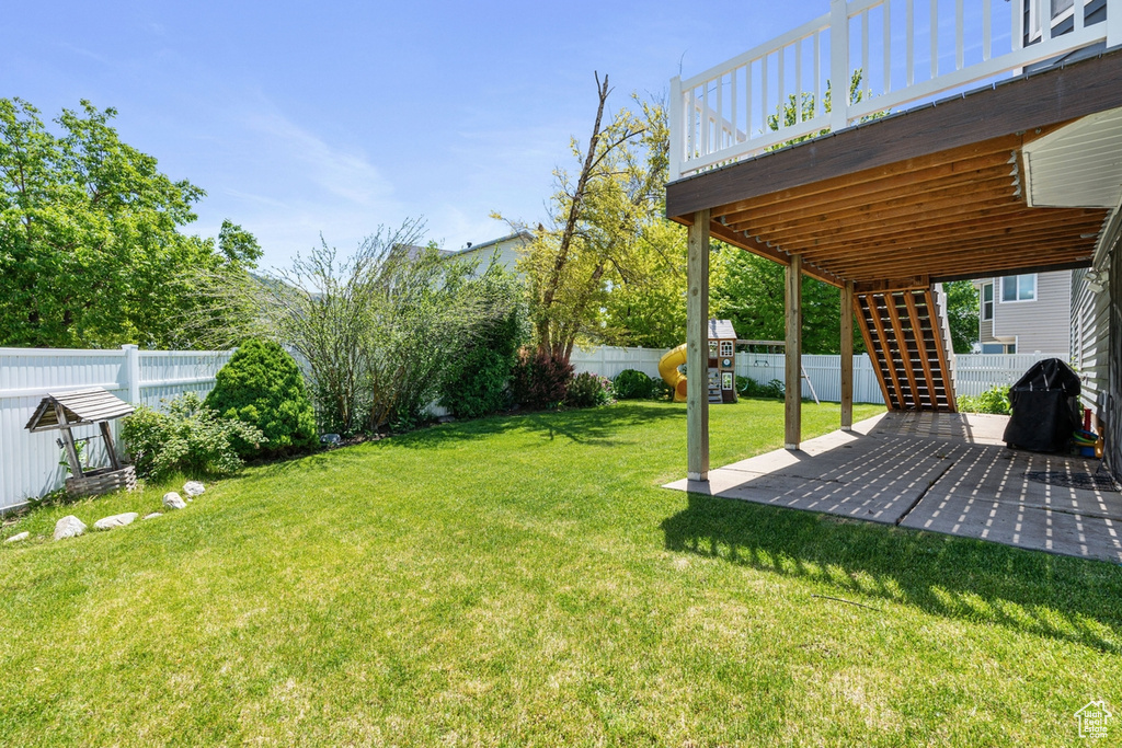 View of yard featuring stairway, a deck, and a patio area