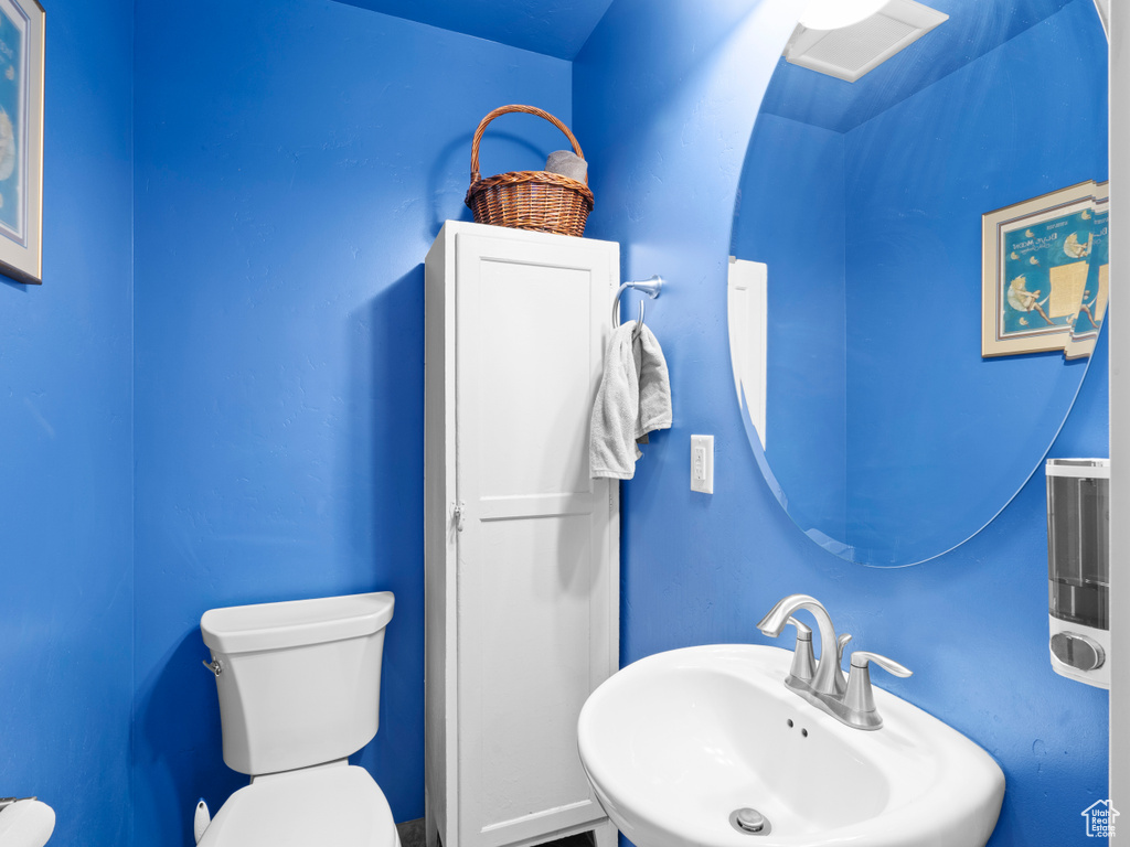 Half bath with a sink and toilet