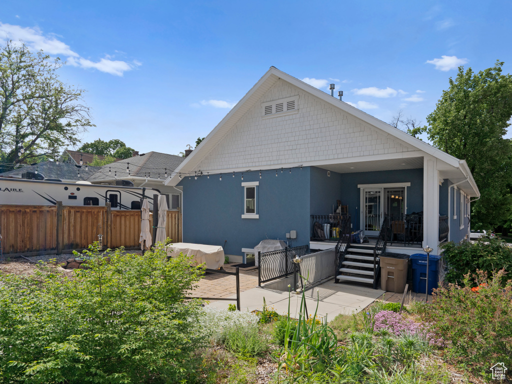Rear view of house featuring stucco siding and a patio area