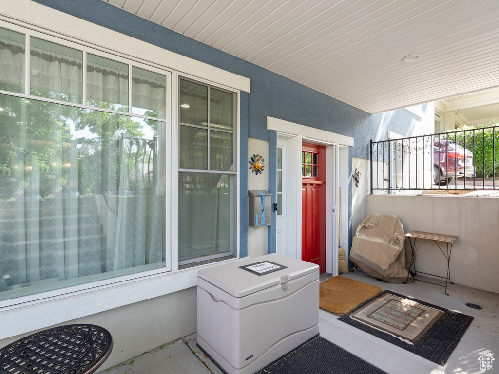 Doorway to property featuring stucco siding