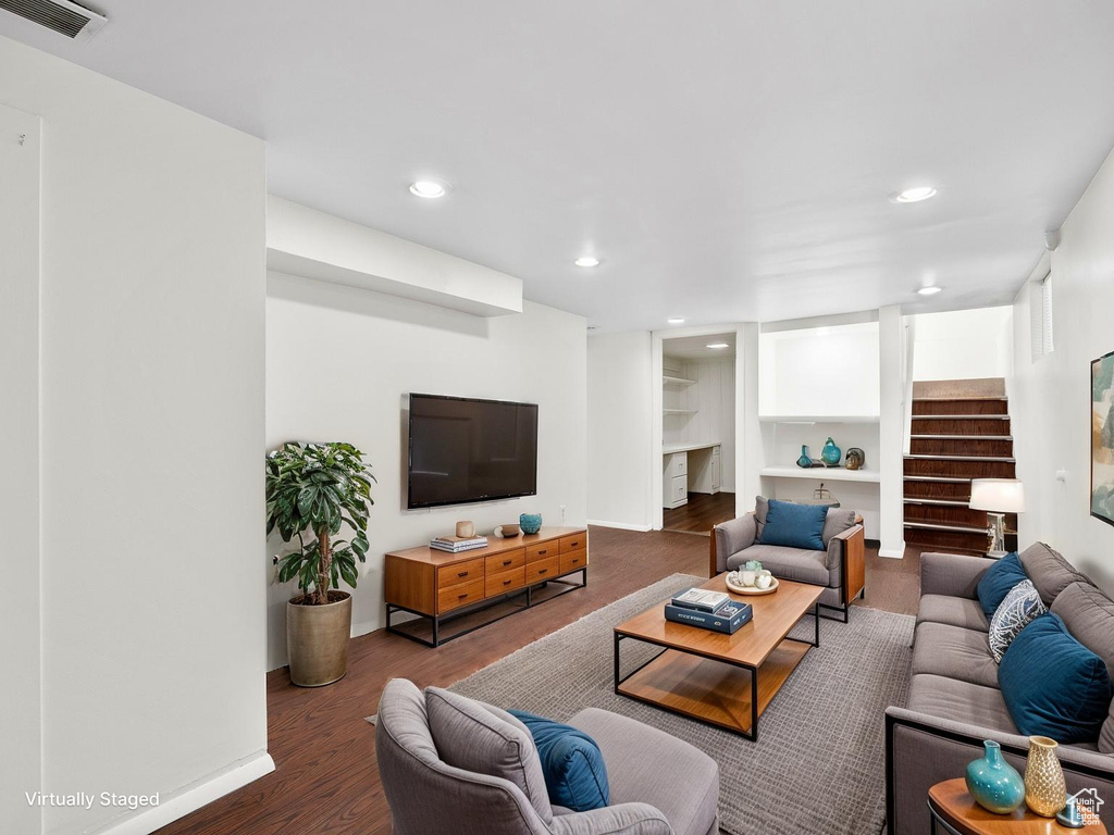 Living room with recessed lighting, wood finished floors, visible vents, and baseboards