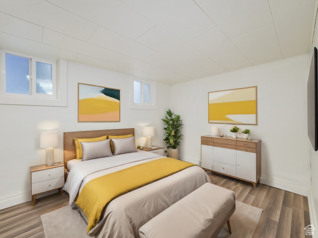 Bedroom featuring wood finished floors and baseboards