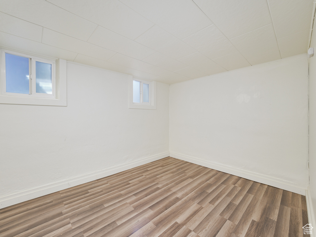 Basement featuring light wood-style floors and baseboards
