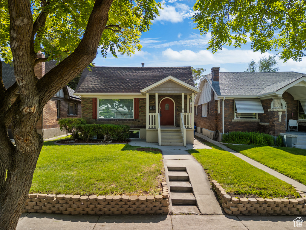 View of front of home featuring brick siding and a front yard