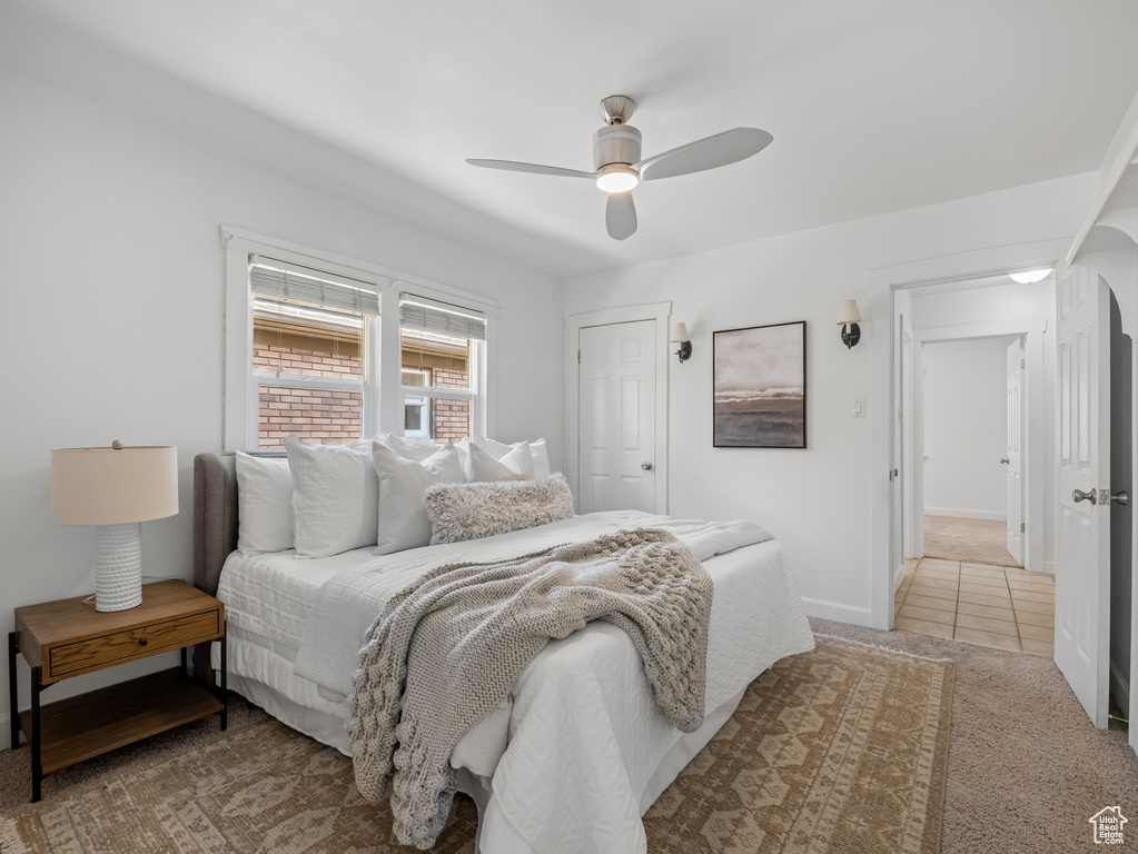 Bedroom with light carpet and ceiling fan