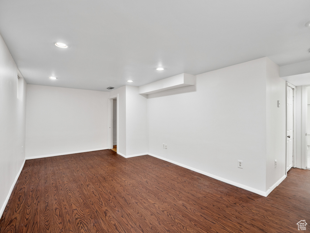 Finished below grade area with dark wood-style floors, baseboards, and recessed lighting