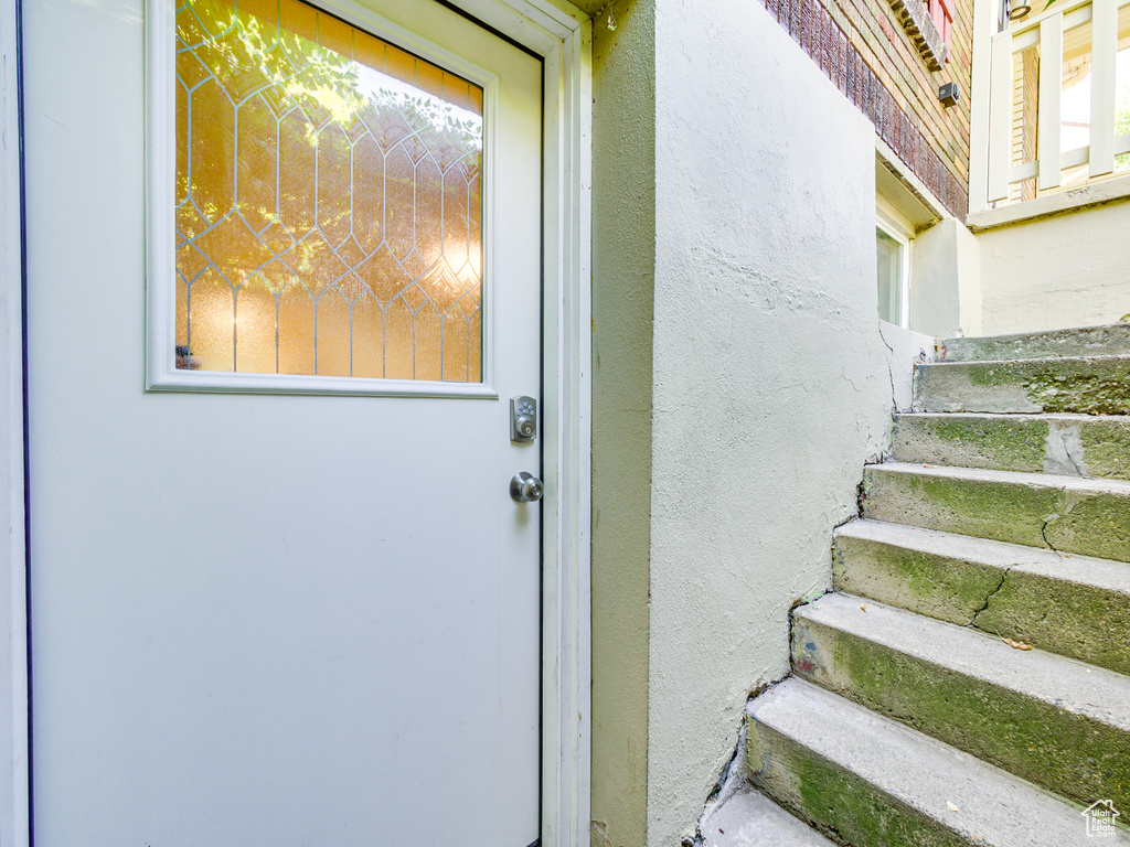 Entrance to property with stucco siding