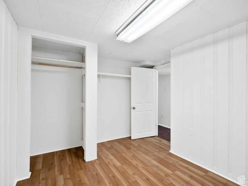 Unfurnished bedroom featuring light wood-style flooring and a closet