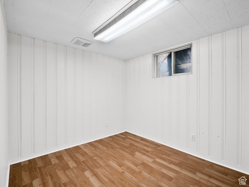Finished below grade area with light wood-style flooring