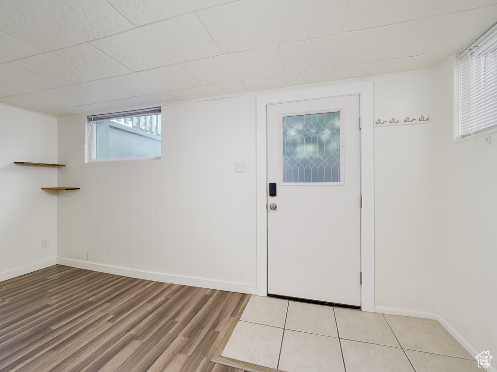 Foyer entrance with light wood-style flooring, baseboards, and healthy amount of natural light