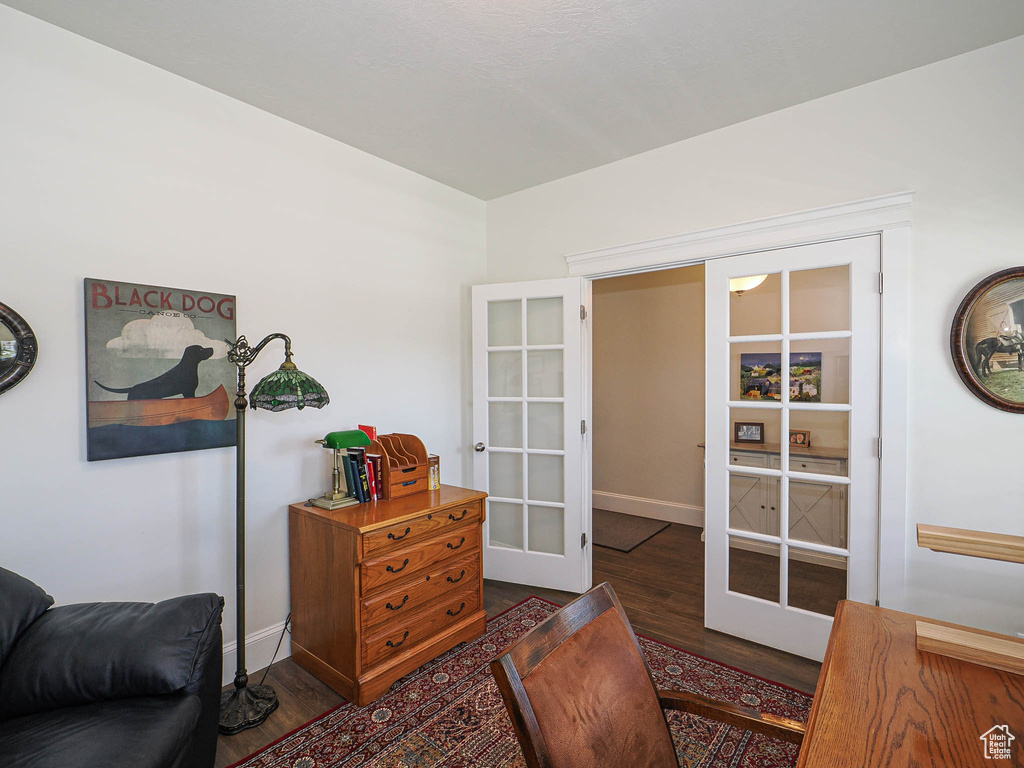 Living area featuring french doors, wood finished floors, and baseboards