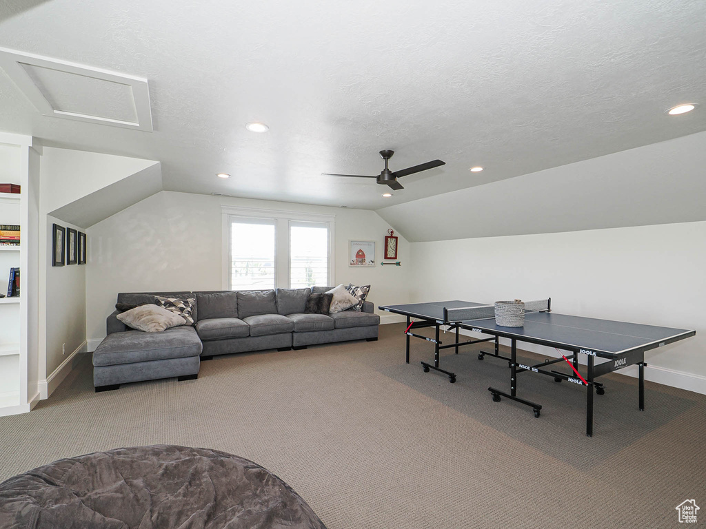 Recreation room featuring carpet flooring, baseboards, ceiling fan, lofted ceiling, and recessed lighting