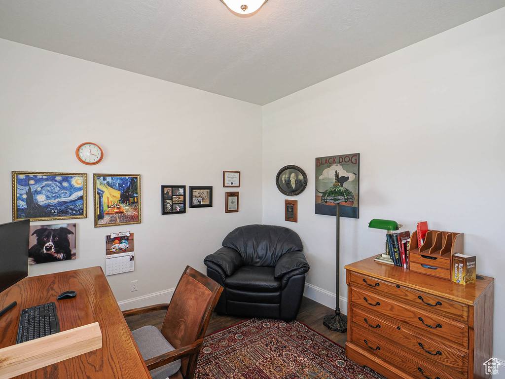 Office space featuring baseboards and wood finished floors