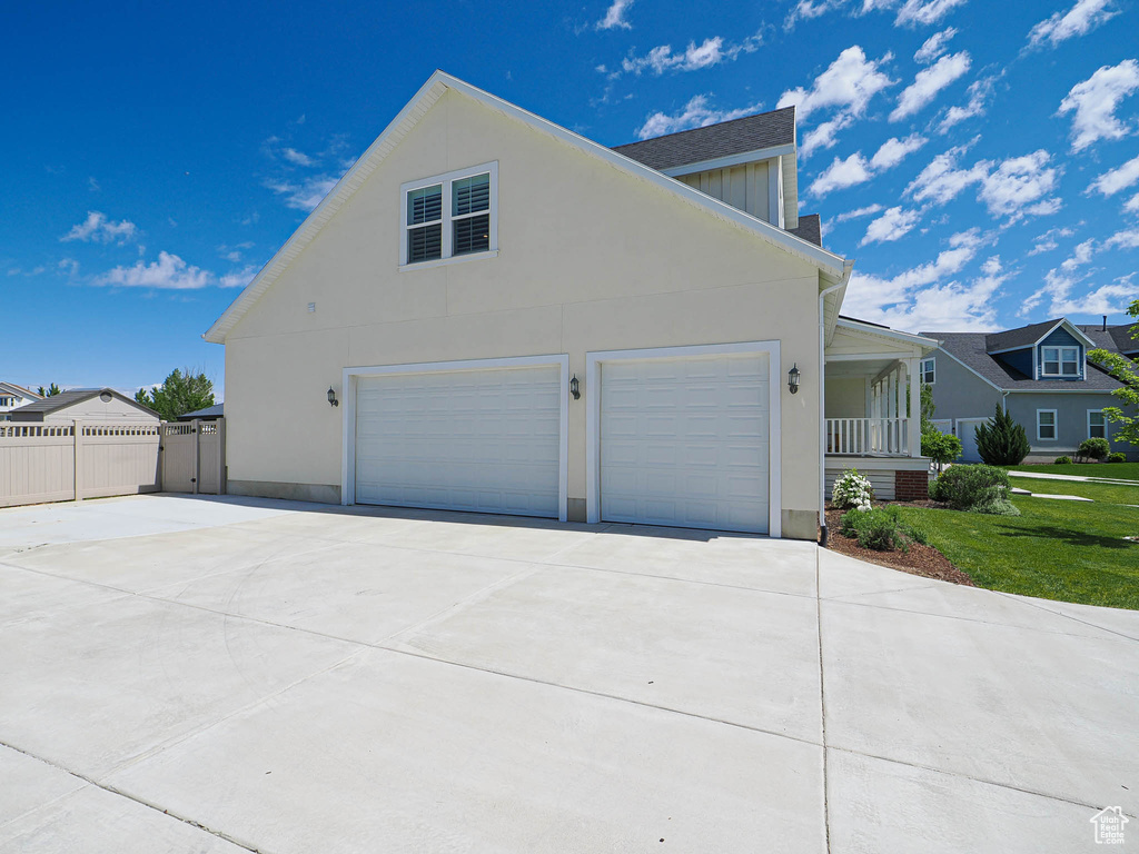View of home\\\'s exterior featuring a garage, concrete driveway, and stucco siding