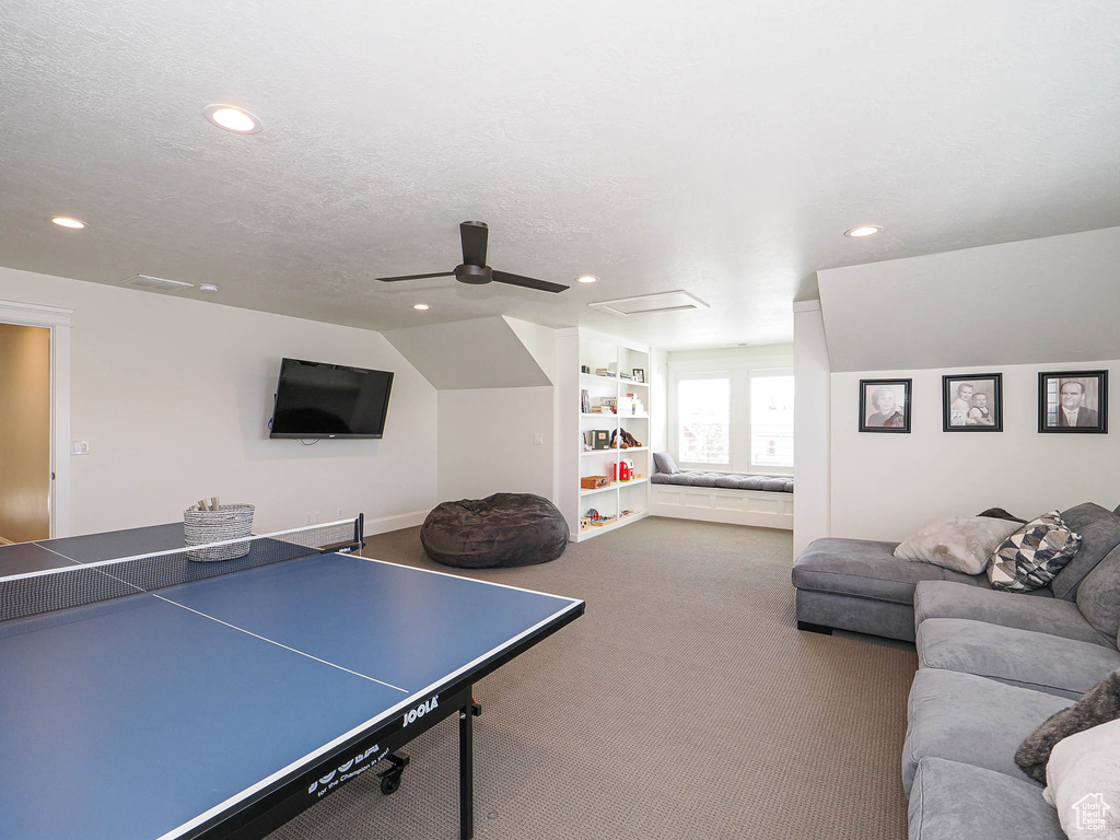 Game room with recessed lighting, carpet, a ceiling fan, a textured ceiling, and built in features