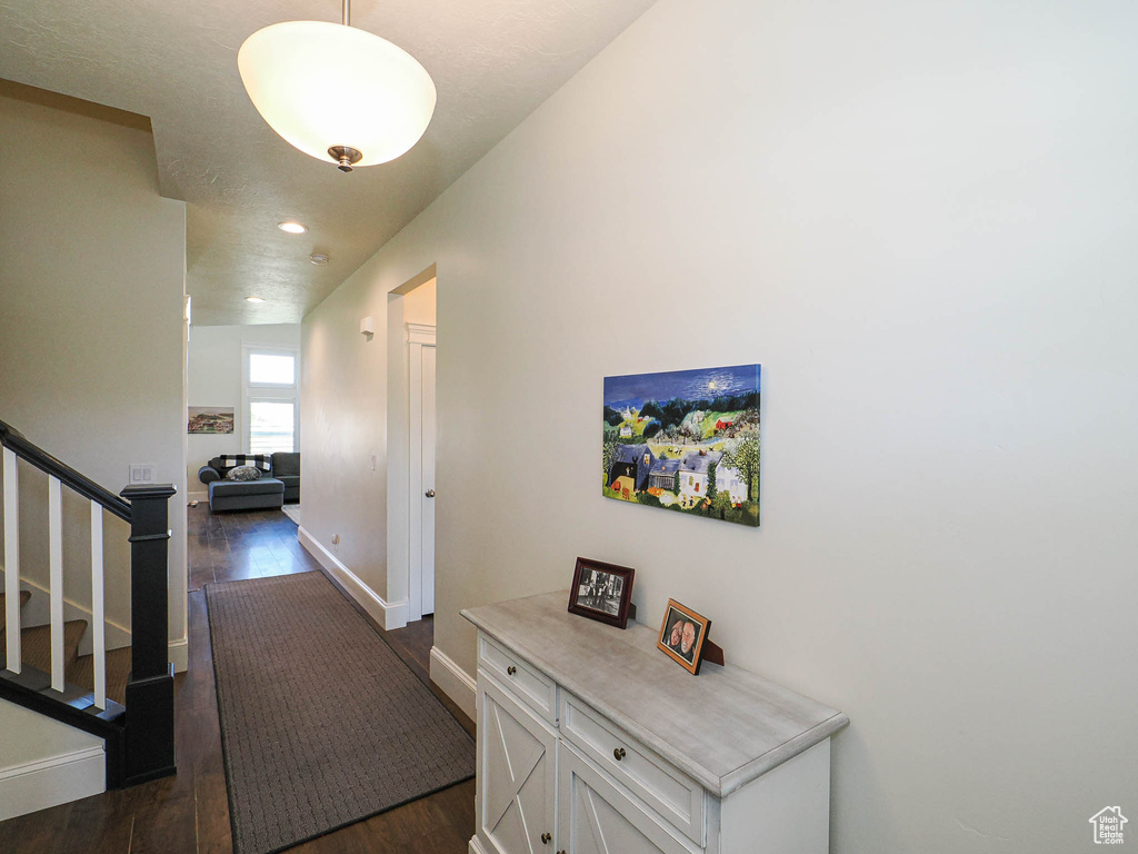 Hall featuring baseboards, stairway, dark wood finished floors, and recessed lighting