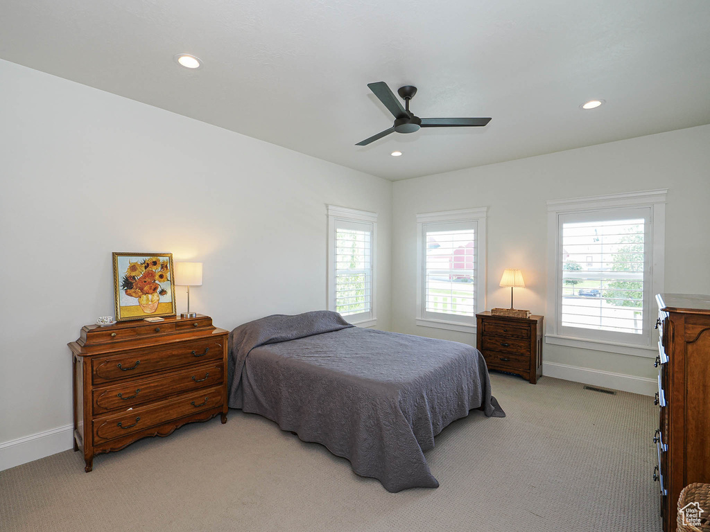 Bedroom featuring light carpet, recessed lighting, baseboards, and a ceiling fan