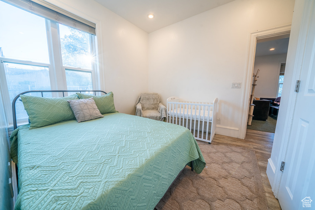 Bedroom featuring multiple windows, recessed lighting, and baseboards