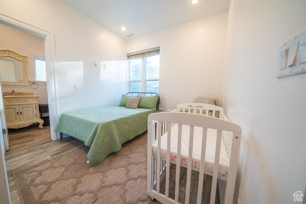 Bedroom with lofted ceiling and recessed lighting