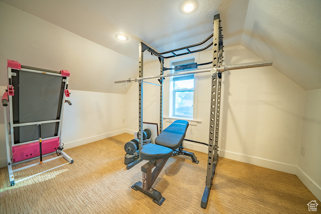 Exercise area with lofted ceiling, baseboards, carpet flooring, and recessed lighting