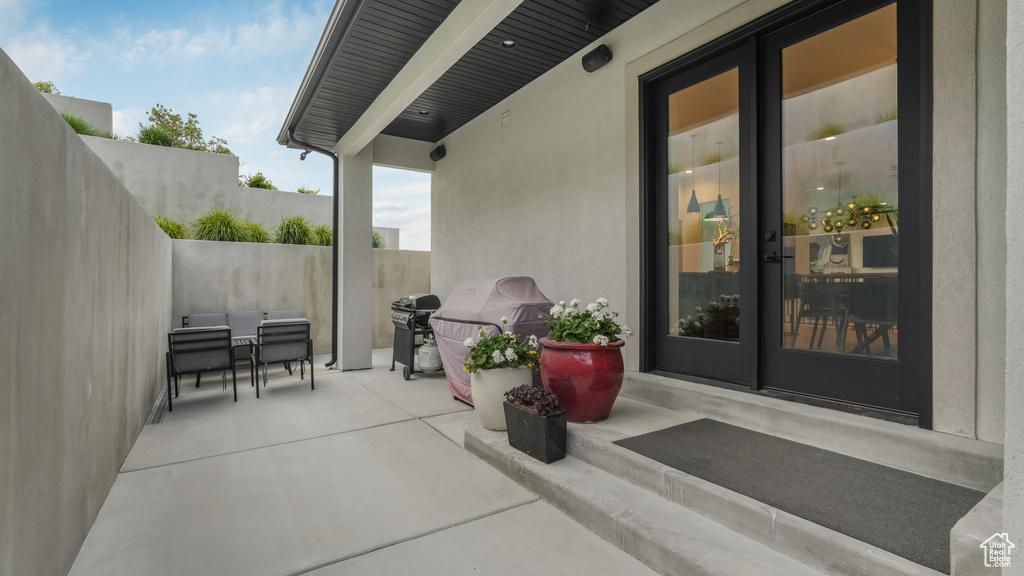 View of patio with french doors and area for grilling