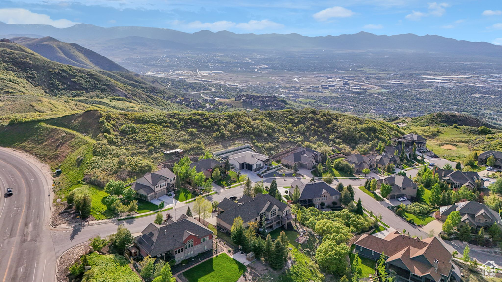 Aerial overview of property's location featuring mountains and nearby suburban area