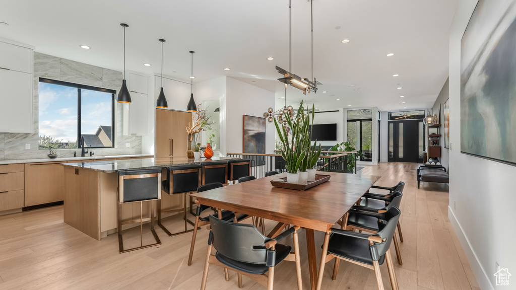 Dining space with recessed lighting and light wood finished floors