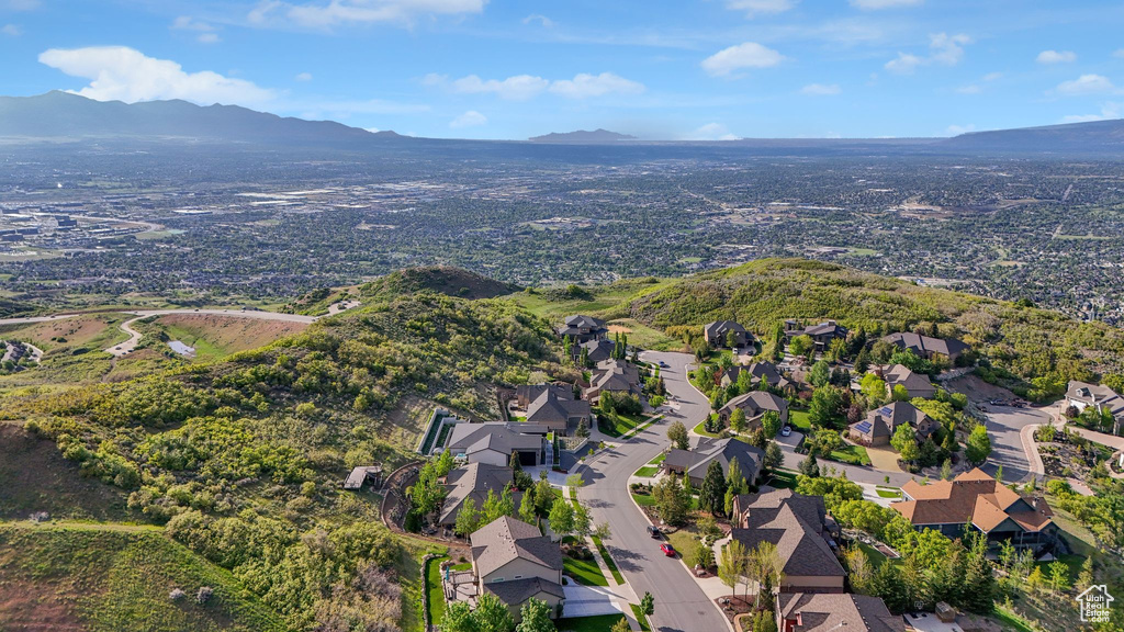 Aerial overview of property's location featuring a mountain backdrop and nearby suburban area