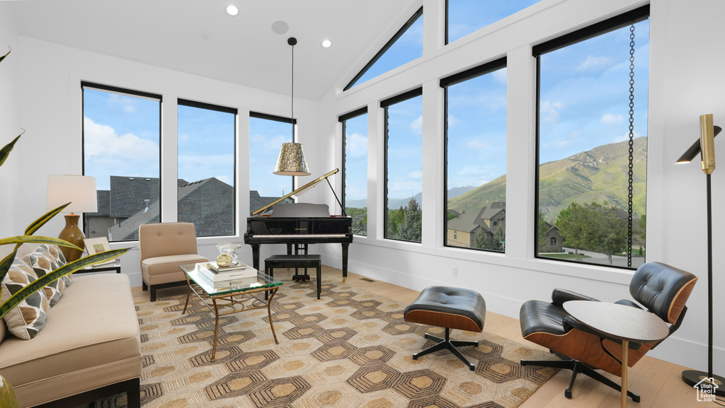 Sitting room featuring healthy amount of natural light, wood finished floors, recessed lighting, baseboards, and a mountain view