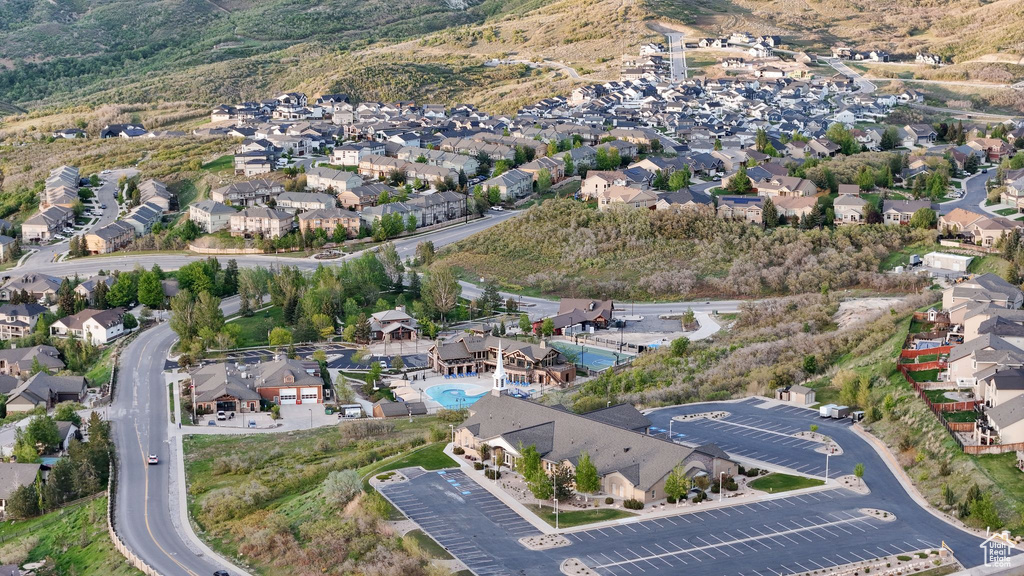 Aerial view of property and surrounding area with nearby suburban area and a pool