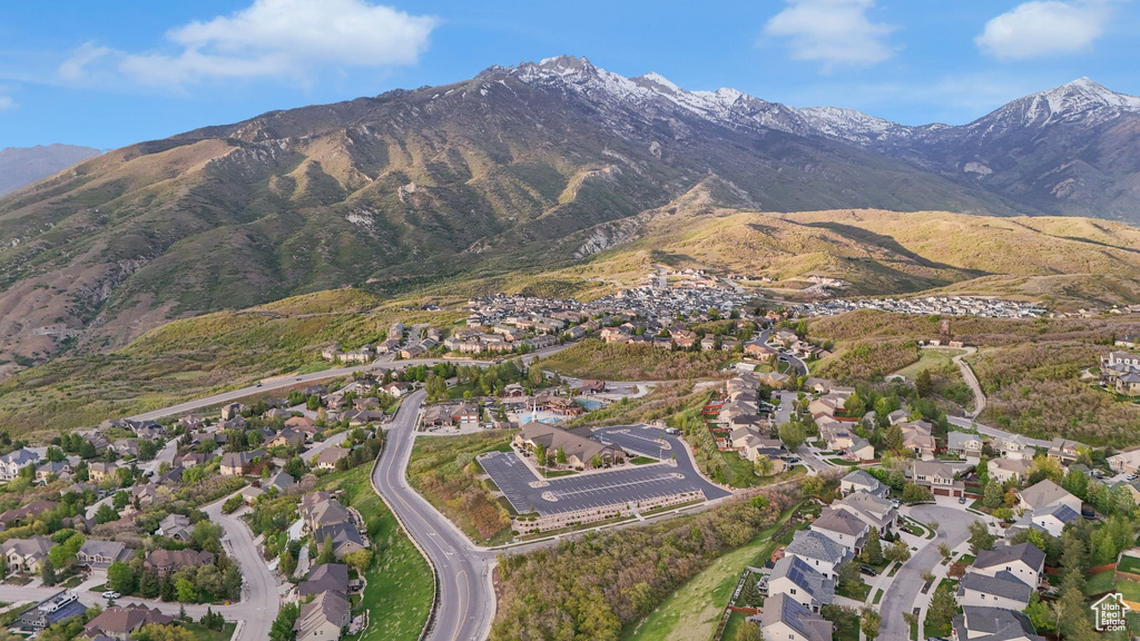 Aerial view of property's location with mountains and nearby suburban area