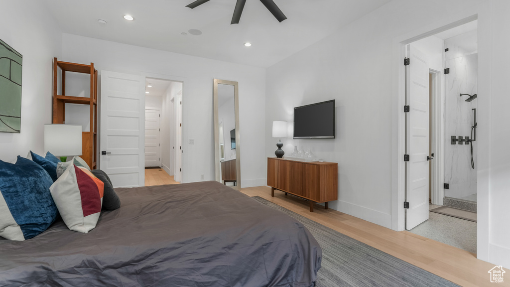 Bedroom with light wood finished floors, recessed lighting, ensuite bathroom, and baseboards