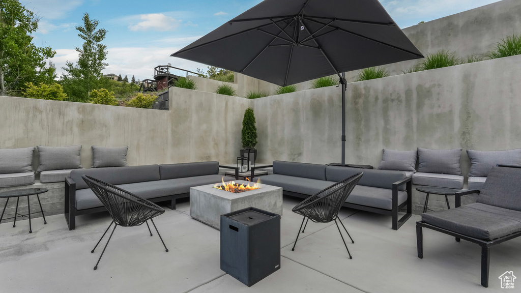 View of patio / terrace with an outdoor living space with a fire pit