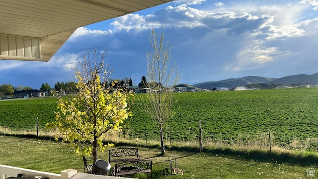 View of yard with a mountain view, agricultural plots, and a view of countryside