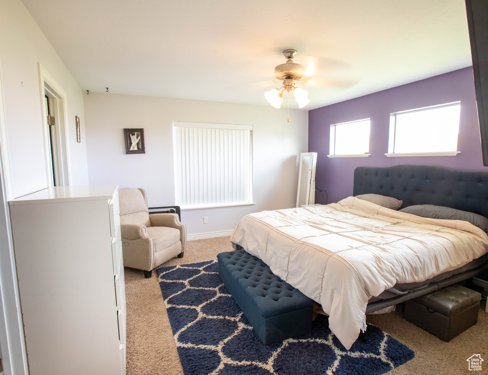 Bedroom with carpet flooring, baseboards, and ceiling fan