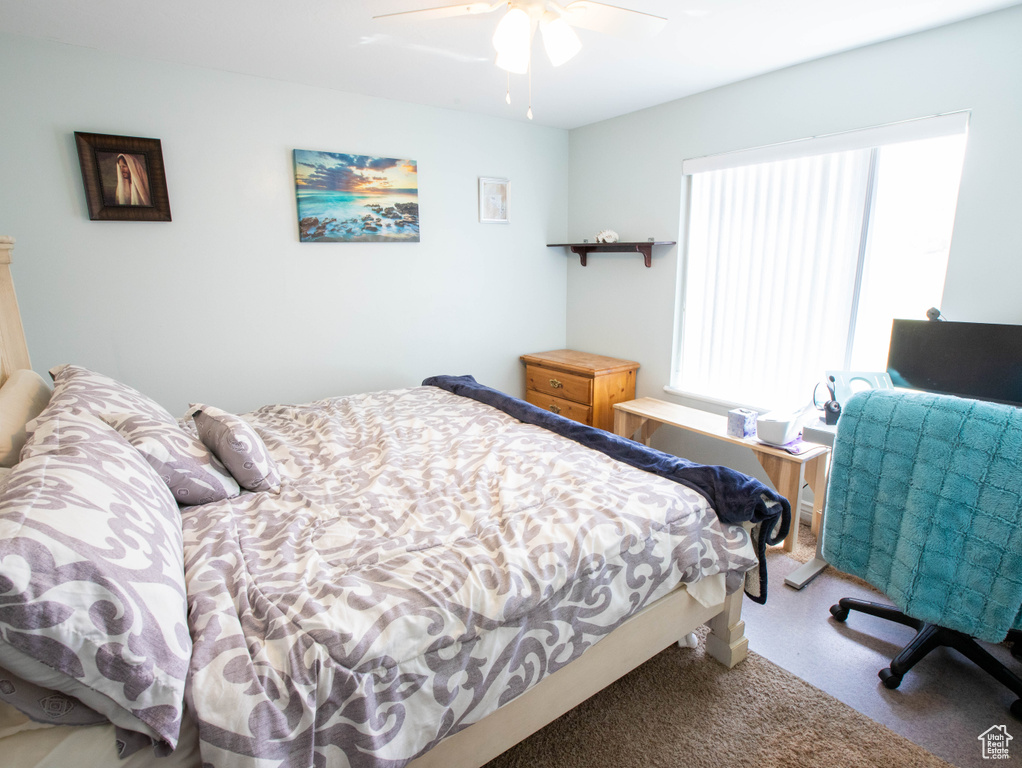 Bedroom with multiple windows and a ceiling fan