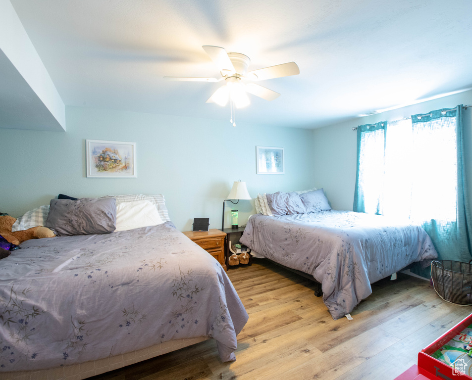 Bedroom with wood finished floors and ceiling fan