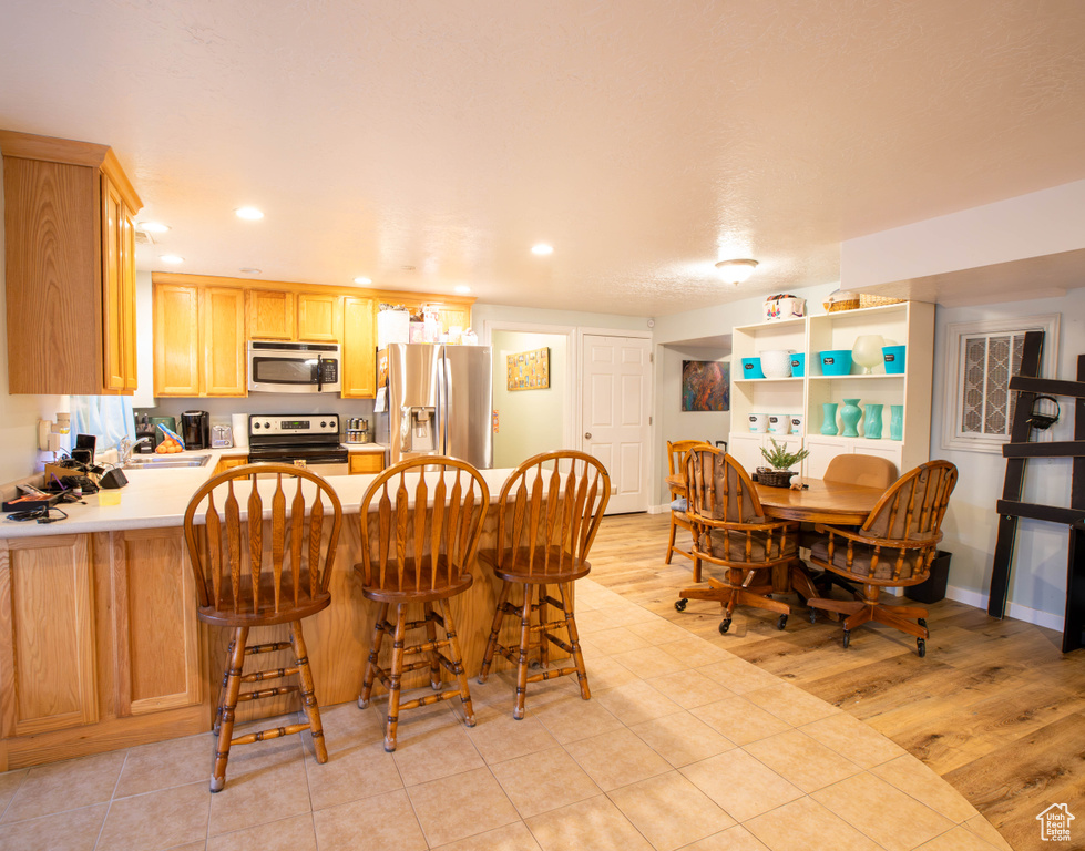 Dining space featuring recessed lighting and light wood-style flooring