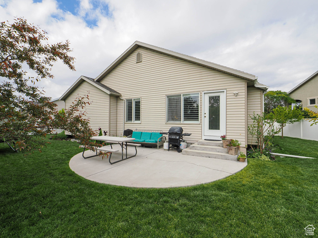 Rear view of property featuring a patio area and outdoor lounge area