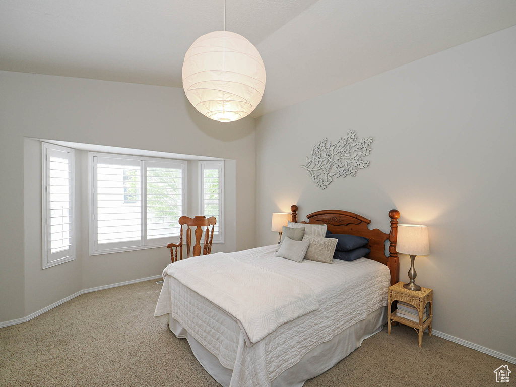 Bedroom with light carpet and baseboards